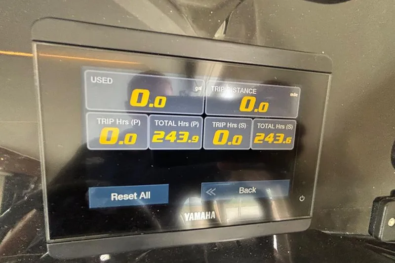 Slide: The Image of 2022 Jeanneau NC Weekender 1095 Flybridge, docked with Garmin equipment, overlooking serene water. - 25