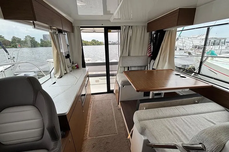 Slide: The Image of 2022 Jeanneau NC Weekender 1095 Fly, flybridge view, docked with covered seating and table. - 26