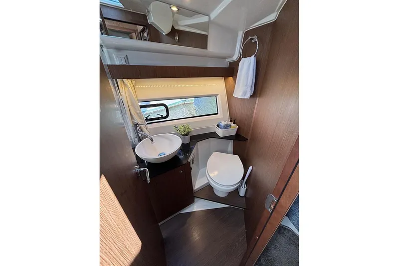 Slide: The Image of 2022 Jeanneau NC Weekender 1095 Fly bathroom with modern fixtures and window view. - 40