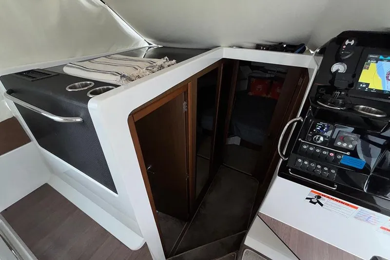 Slide: The Image of Interior of 2022 Jeanneau NC Weekender 1095 Fly, featuring helm and cabin entrance. - 45