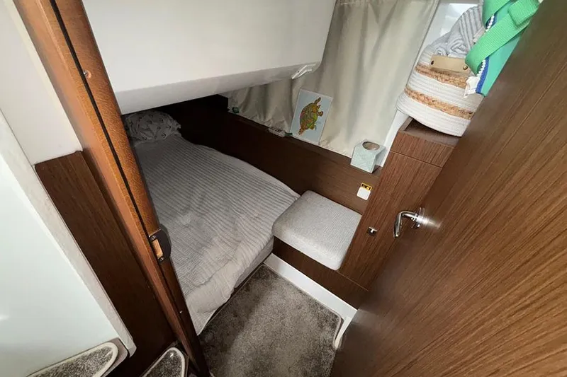 Slide: The Image of Cozy cabin interior of 2022 Jeanneau NC Weekender 1095 Fly with bed and storage. - 52