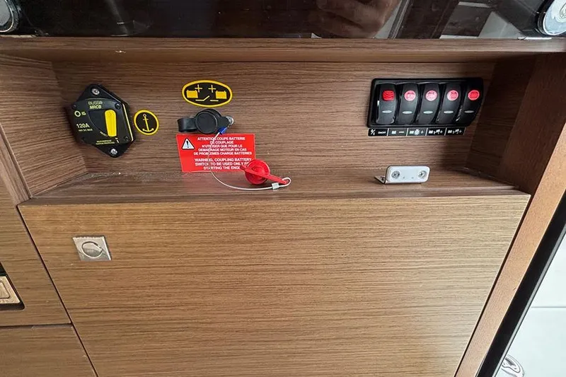 Slide: The Image of Control panel of 2022 Jeanneau NC Weekender 1095 Fly with switches and warning labels. - 57