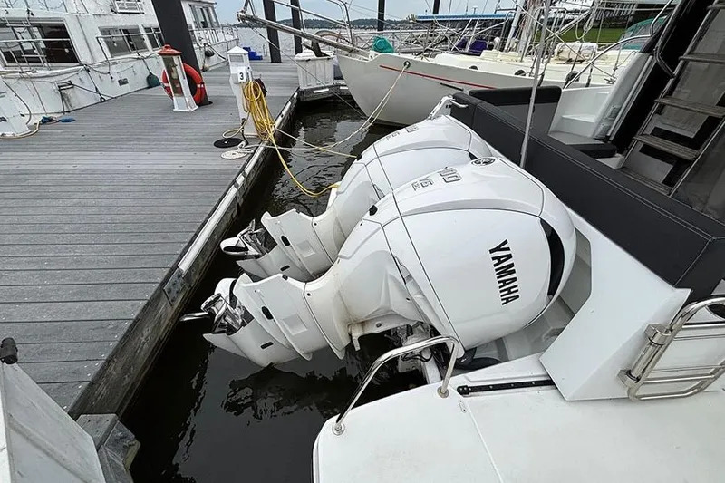 Slide: The Image of 2022 Jeanneau NC Weekender 1095 Fly docked with twin outboard engines. - 6