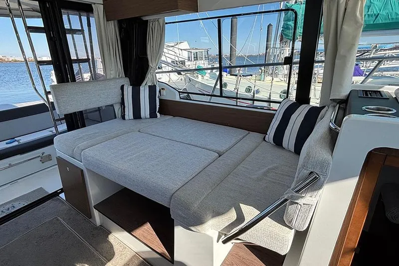 Slide: The Image of Interior of 2022 Jeanneau NC Weekender 1095 Fly with cozy seating and marina view. - 63