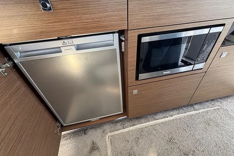 Slide: The Image of Modern kitchen appliances in 2022 Jeanneau NC Weekender 1095 Fly yacht interior. - 67