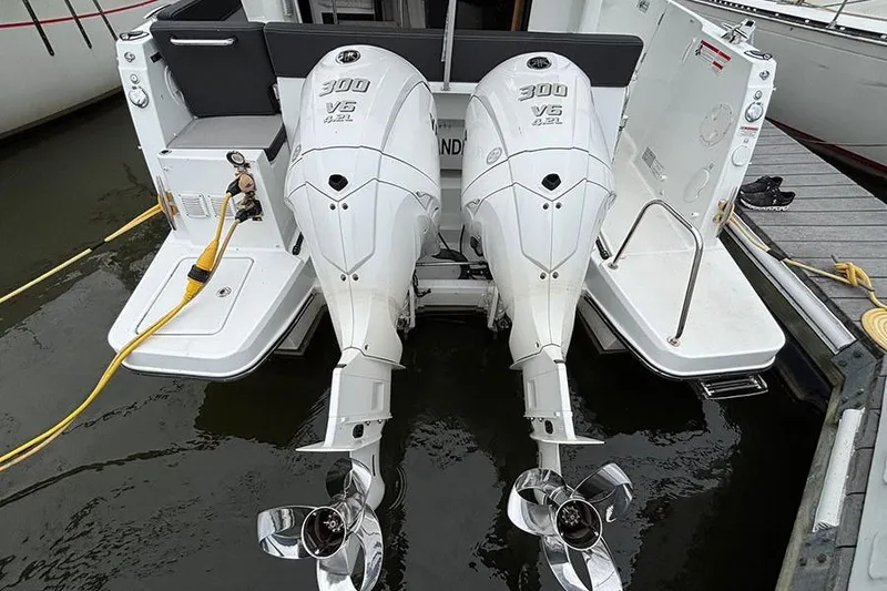 Slide: The Image of Twin propellers of a 2022 Jeanneau NC Weekender 1095 Fly boat in water. - 8