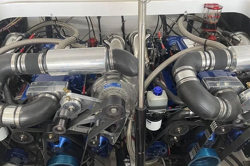 Slide: The Image of Engine compartment of a 2001 Fountain 35 Lightning boat, showcasing dual high-performance engines. - 19