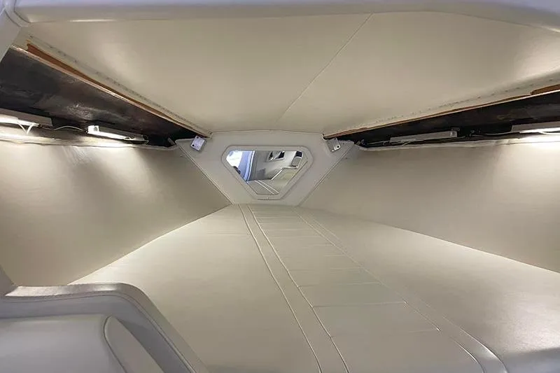 Slide: The Image of Interior cabin of a 2001 Fountain 35 Lightning boat, featuring sleek white design. - 23