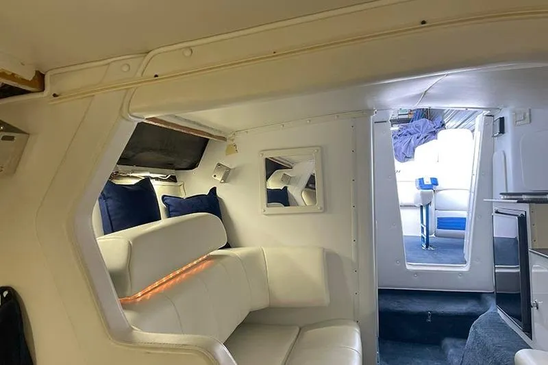 Slide: The Image of Interior of a 2001 Fountain 35 Lightning boat with white seating and blue accents. - 25