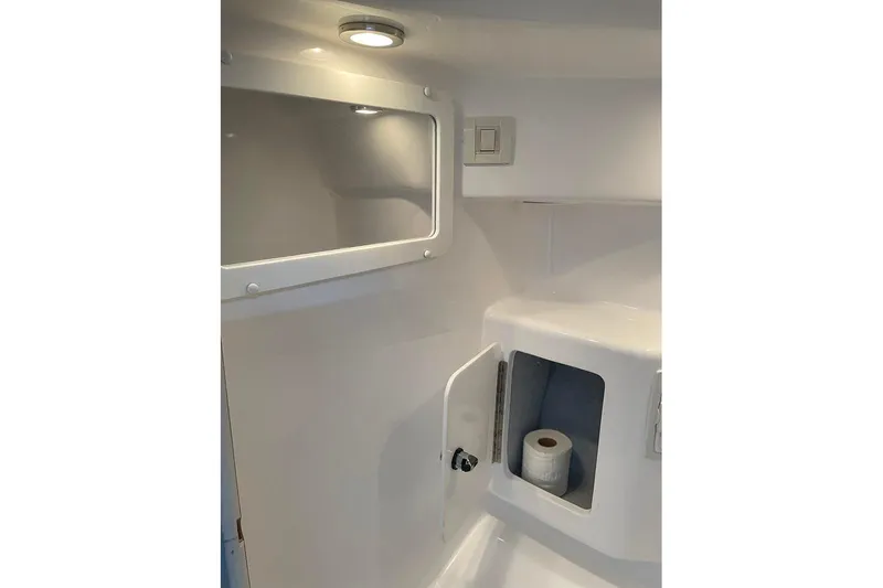 Slide: The Image of 2001 Fountain 35 Lightning boat interior with storage compartment and toilet paper. - 28