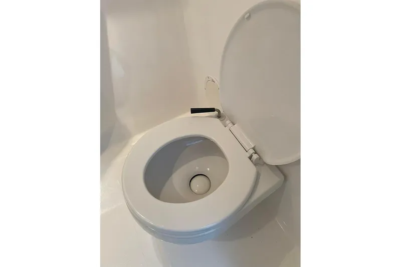 Slide: The Image of White toilet seat in a 2001 Fountain 35 Lightning boat bathroom. - 29