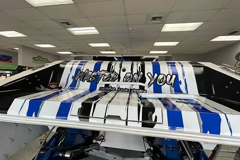 Slide: The Image of 2001 Fountain 35 Lightning boat with "Wasted On You" graphic, blue and white stripes. - 6