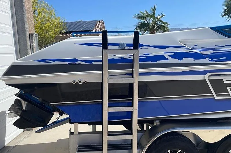 Slide: The Image of 2001 Fountain 35 Lightning boat with blue and white design on trailer. - 7