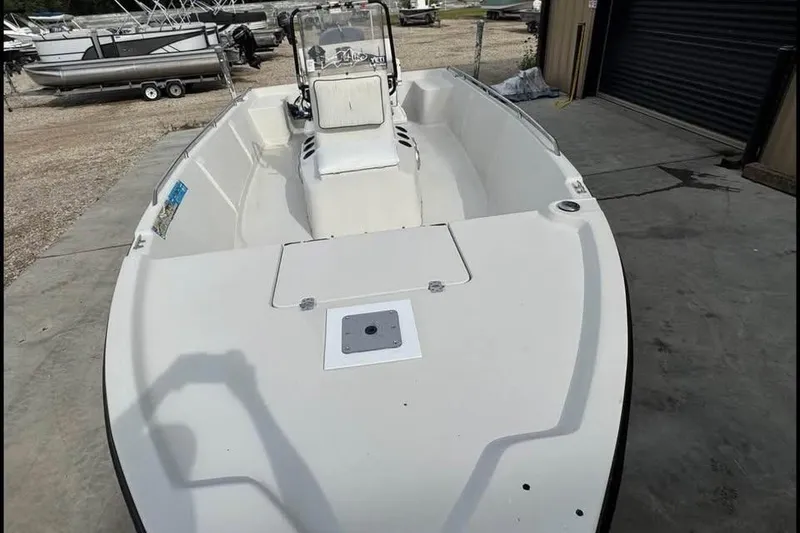 Slide: The Image of 2000 Pathfinder 1806 V boat, white deck, parked outdoors near other boats. - 13