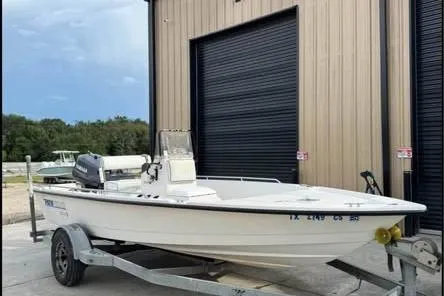 Slide: The Image of 2000 Pathfinder 1806 V boat on trailer, parked outside a storage facility. - 5