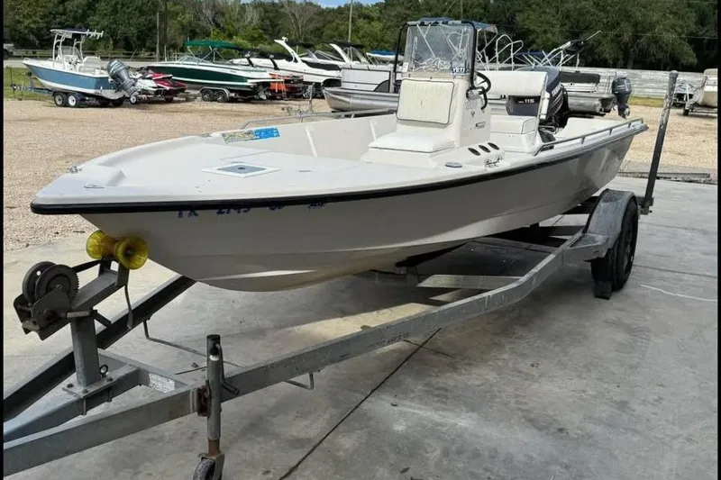 Slide: The Image of 2000 Pathfinder 1806 V boat on trailer, parked outdoors with other boats in background. - 6
