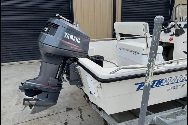 Slide: The Image of Pathfinder 1806 V boat with Yamaha outboard motor, parked in a garage. - 9
