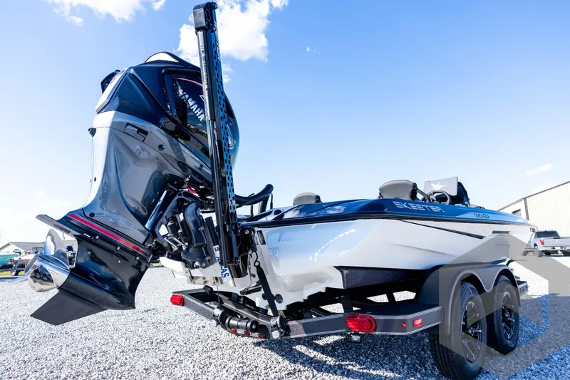 Slide: The Image of 2026 Skeeter ZXE20 boat with Yamaha outboard motor, parked on gravel under blue sky. - 17