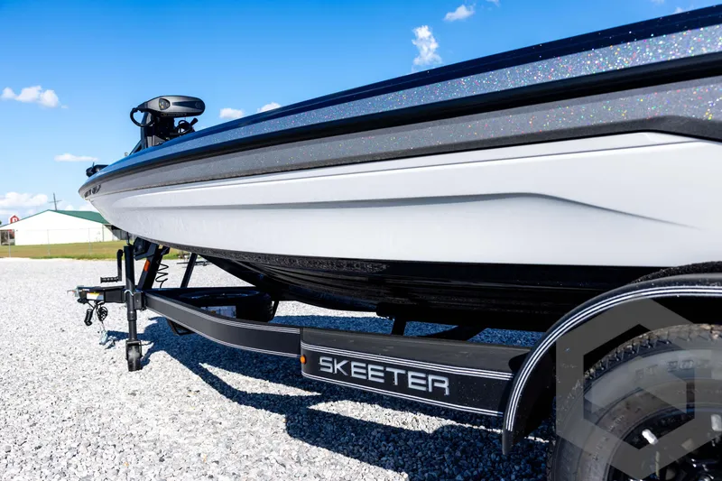 Slide: The Image of 2026 Skeeter ZXE20 boat on trailer, parked on gravel under clear blue sky. - 30
