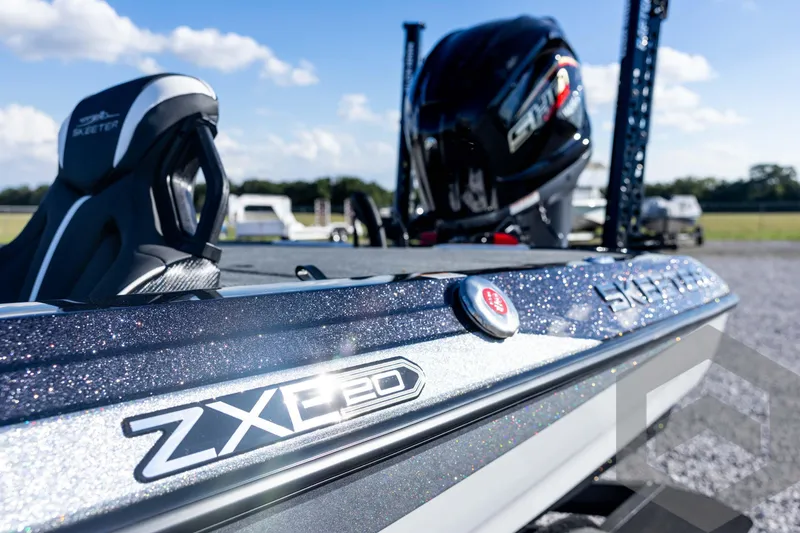 Slide: The Image of 2026 Skeeter ZXE20 boat with sleek design and modern features, parked outdoors. - 32