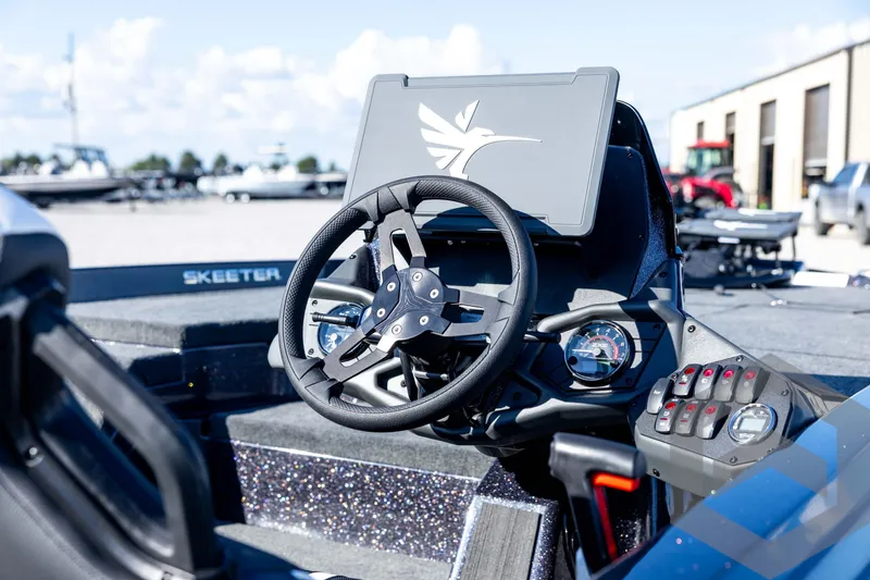 Slide: The Image of 2026 Skeeter ZXE20 boat dashboard with steering wheel and control panel. - 36