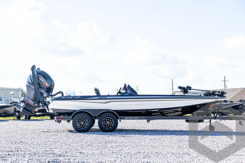 Slide: The Image of 2026 Skeeter ZXE20 boat on trailer, side view, outdoors on gravel. - 4