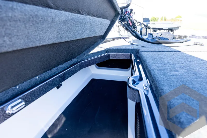 Slide: The Image of Interior view of 2026 Skeeter ZXE20 boat storage compartment with open lid. - 48