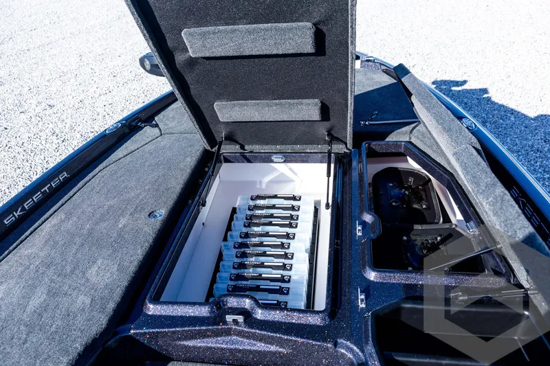 Slide: The Image of Open storage compartment in 2026 Skeeter ZXE20 boat, showcasing organized battery setup. - 49