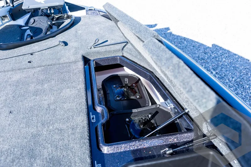 Slide: The Image of 2026 Skeeter ZXE20 boat storage compartment with open lid, showcasing interior details. - 50