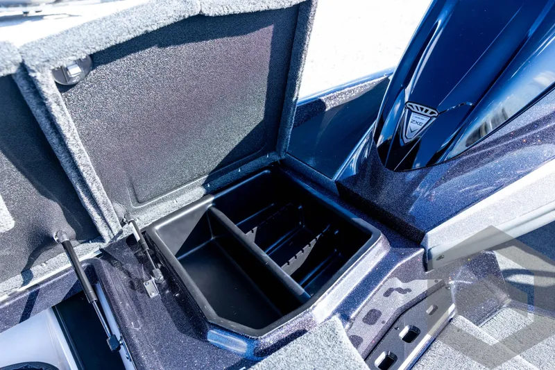 Slide: The Image of 2026 Skeeter ZXE20 boat storage compartment with open lid and sleek design. - 51