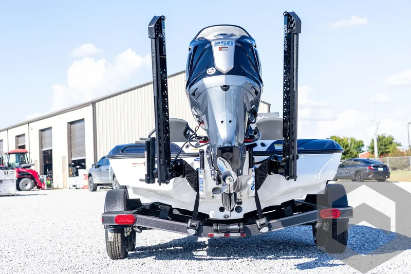 Slide: The Image of 2026 Skeeter ZXE20 boat with powerful outboard motor, parked on gravel near industrial buildings. - 6