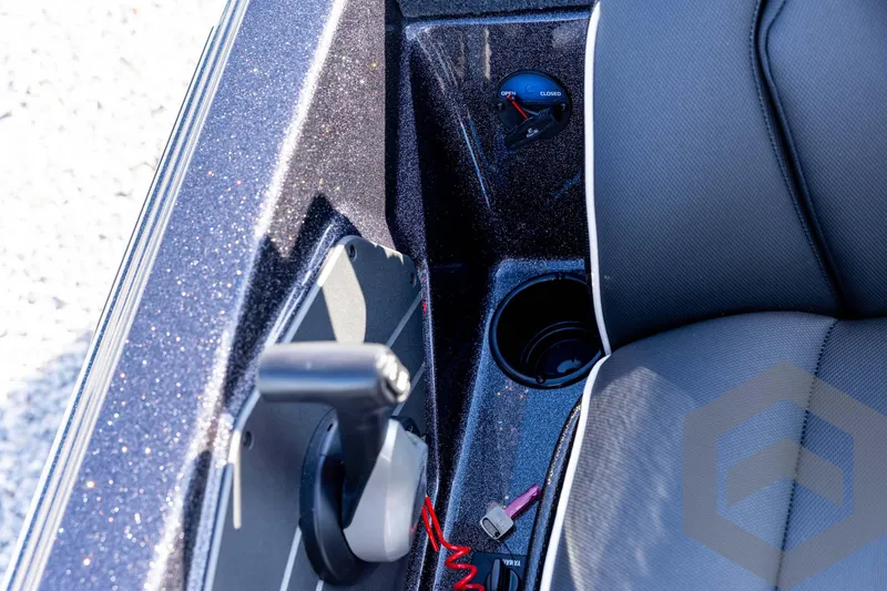 Slide: The Image of Interior of 2026 Skeeter ZXE20 boat with control lever and cup holder. - 66