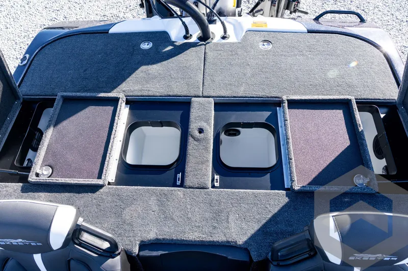 Slide: The Image of 2026 Skeeter ZXE20 boat deck with open storage compartments and seating. - 68