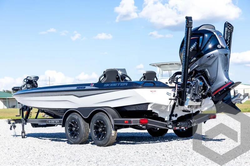 Slide: The Image of 2026 Skeeter ZXE20 boat with Yamaha engine on a trailer, parked outdoors. - 7