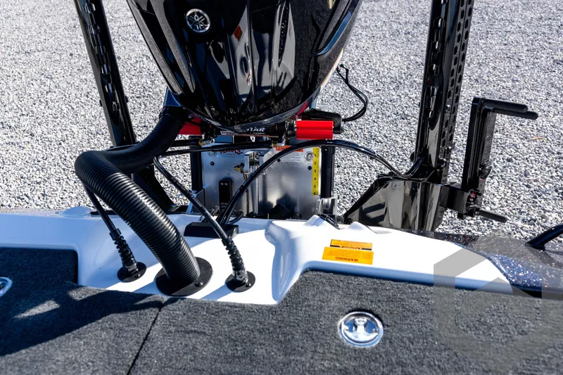 Slide: The Image of 2026 Skeeter ZXE20 boat engine and components on gravel surface. - 74