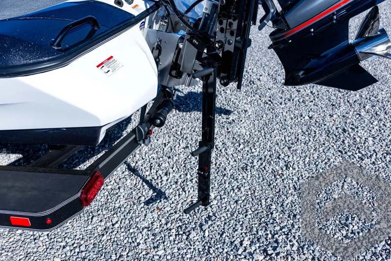 Slide: The Image of Rear view of 2026 Skeeter ZXE20 boat on gravel, showcasing motor and trailer details. - 77