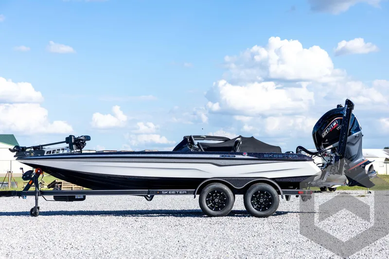Slide: The Image of 2026 Skeeter ZXE20 boat on trailer under blue sky. - 8