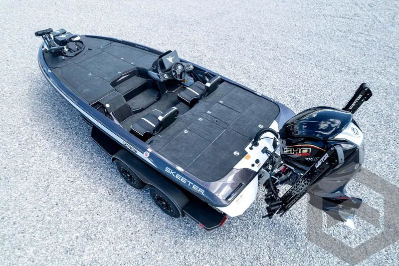 Slide: The Image of 2026 Skeeter ZXE20 fishing boat with advanced motor and sleek design on gravel surface. - 80