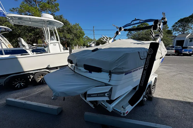 Slide: The Image of 2022 Malibu Wakesetter 23 LSV boat covered and parked on a trailer. - 11