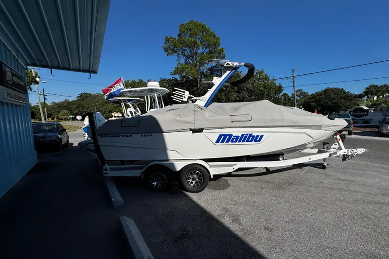 Slide: The Image of 2022 Malibu Wakesetter 23 LSV boat on trailer, covered, parked outside dealership. - 12
