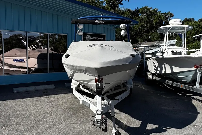 Slide: The Image of 2022 Malibu Wakesetter 23 LSV boat covered and parked outside dealership. - 14