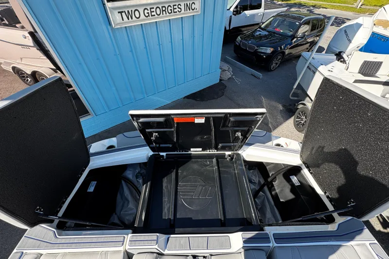 Slide: The Image of 2022 Malibu Wakesetter 23 LSV boat storage compartments open at dealership. - 20