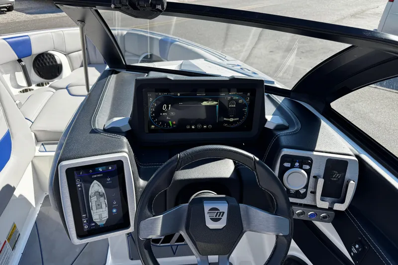 Slide: The Image of 2022 Malibu Wakesetter 23 LSV dashboard with advanced digital controls and steering wheel. - 21