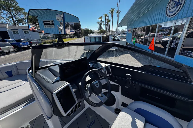 Slide: The Image of Interior view of 2022 Malibu Wakesetter 23 LSV boat, showcasing steering and dashboard. - 23