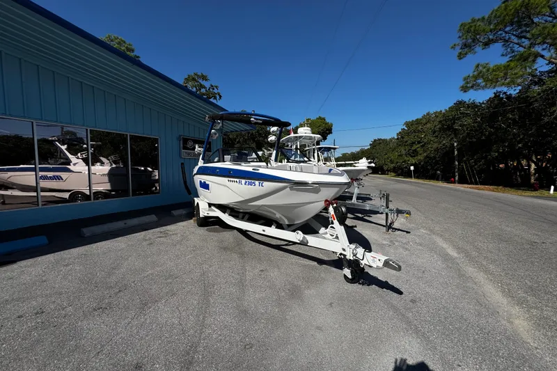 Slide: The Image of 2022 Malibu Wakesetter 23 LSV boat on trailer outside dealership. - 5