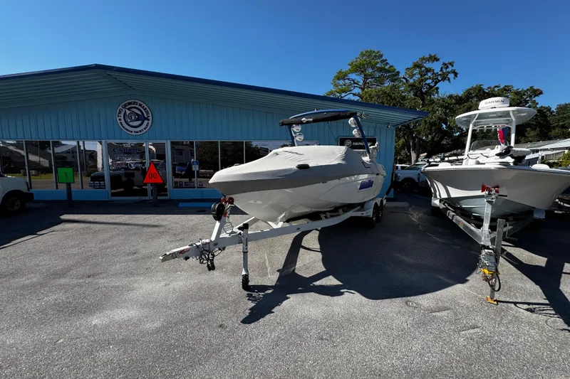 Slide: The Image of 2022 Malibu Wakesetter 23 LSV boat on trailer outside a marine dealership. - 7