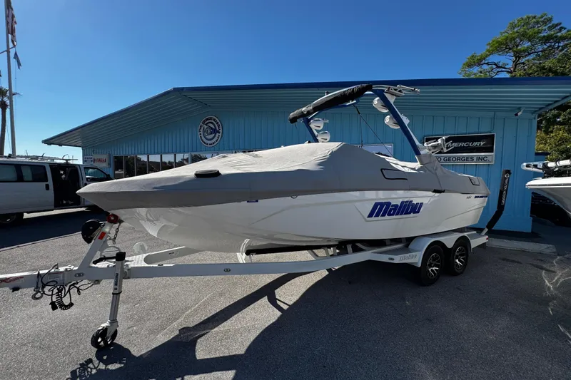 Slide: The Image of 2022 Malibu Wakesetter 23 LSV boat on trailer, covered, outside dealership. - 8