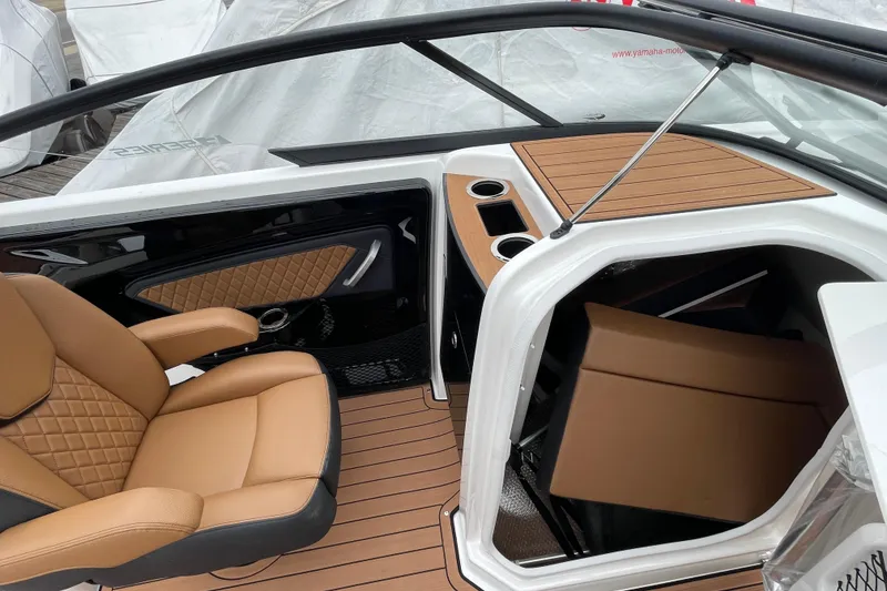 Slide: The Image of 2026 Yamaha Boats 252SE interior with tan seating and wood accents. - 11