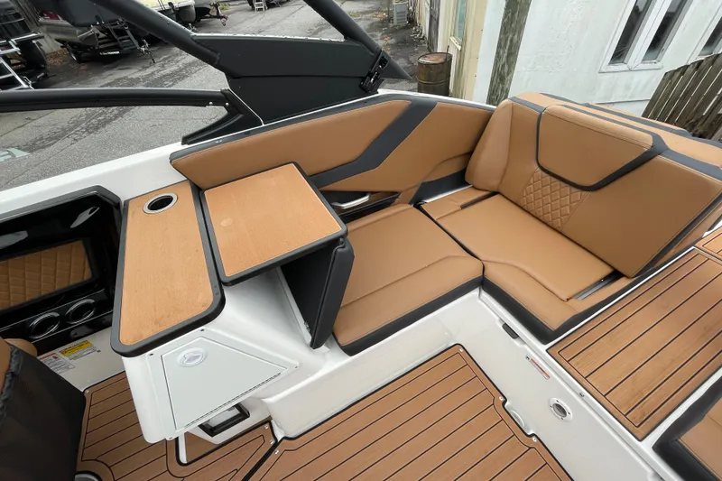 Slide: The Image of 2026 Yamaha Boats 252SE interior with tan seating and wood accents. - 19