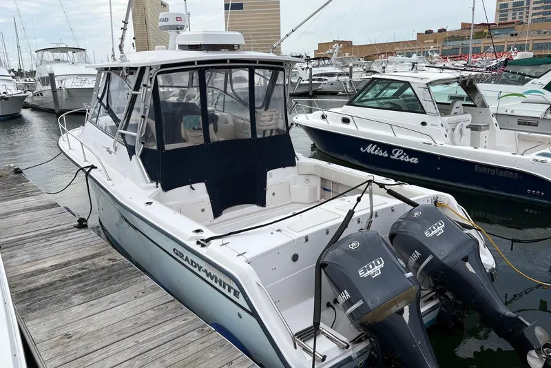The Image of 2004 Grady-White Express 330 boat docked with twin Yamaha engines. - 0